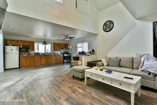 living room with ceiling fan and dark wood-type flooring