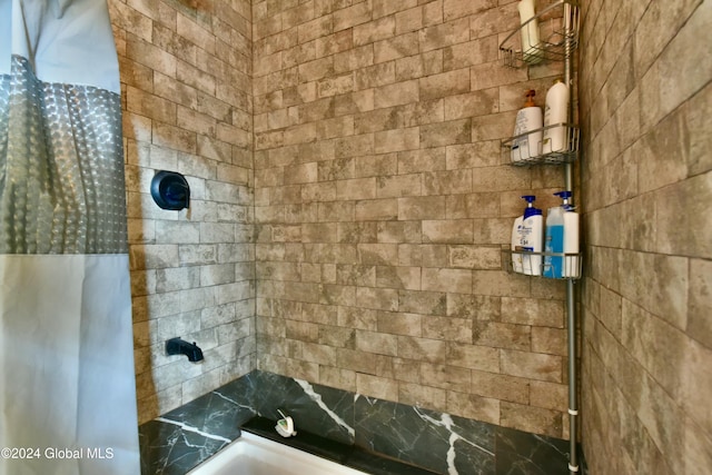 bathroom with tiled shower