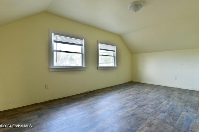 additional living space featuring vaulted ceiling and dark hardwood / wood-style floors