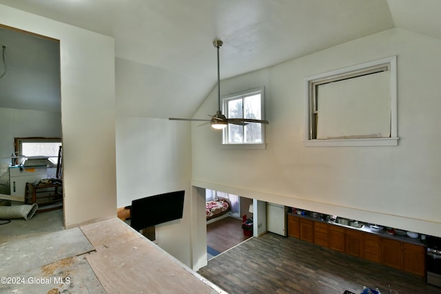 interior space with ceiling fan, wood-type flooring, and lofted ceiling