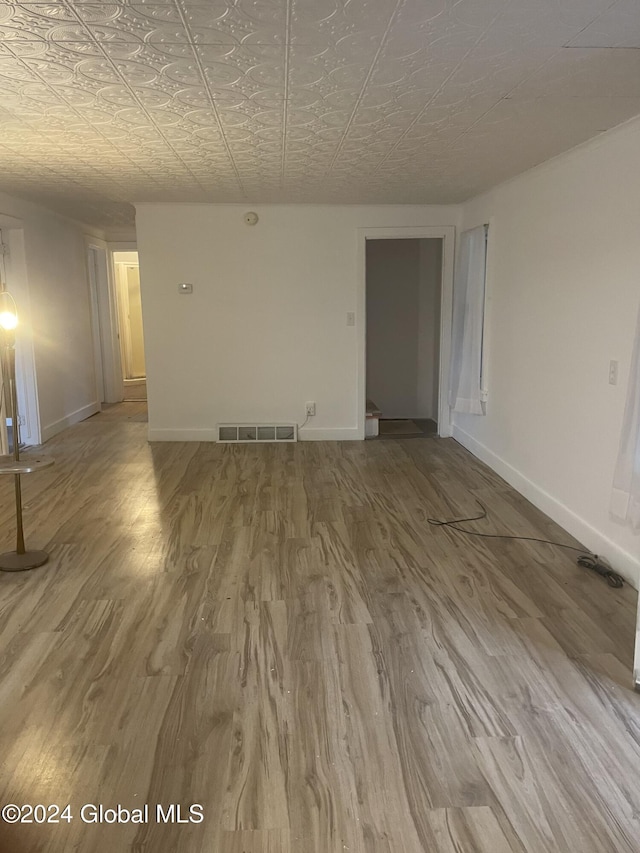 unfurnished room with hardwood / wood-style flooring