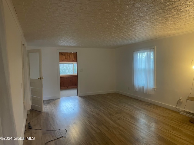 empty room with hardwood / wood-style floors and a textured ceiling