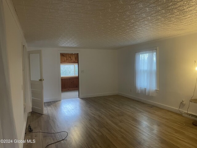 261 Fox Hill Rd, Edinburg, NY 12134 - unfurnished room with baseboards, wood finished floors, and an ornate ceiling