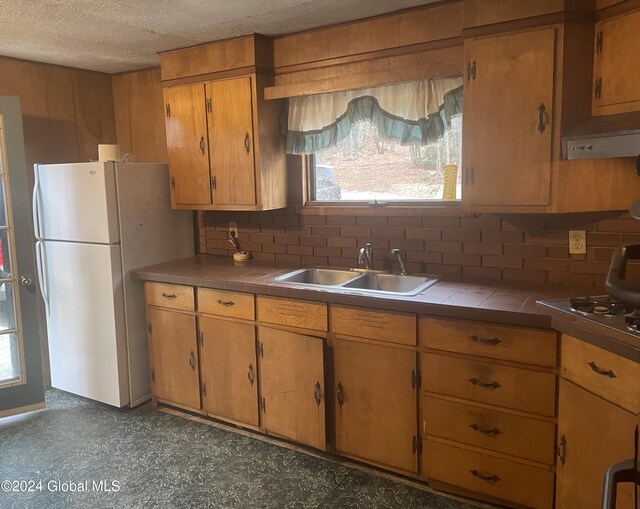 261 Fox Hill Rd, Edinburg, NY 12134 - kitchen featuring tile countertops, a sink, freestanding refrigerator, plenty of natural light, and a textured ceiling