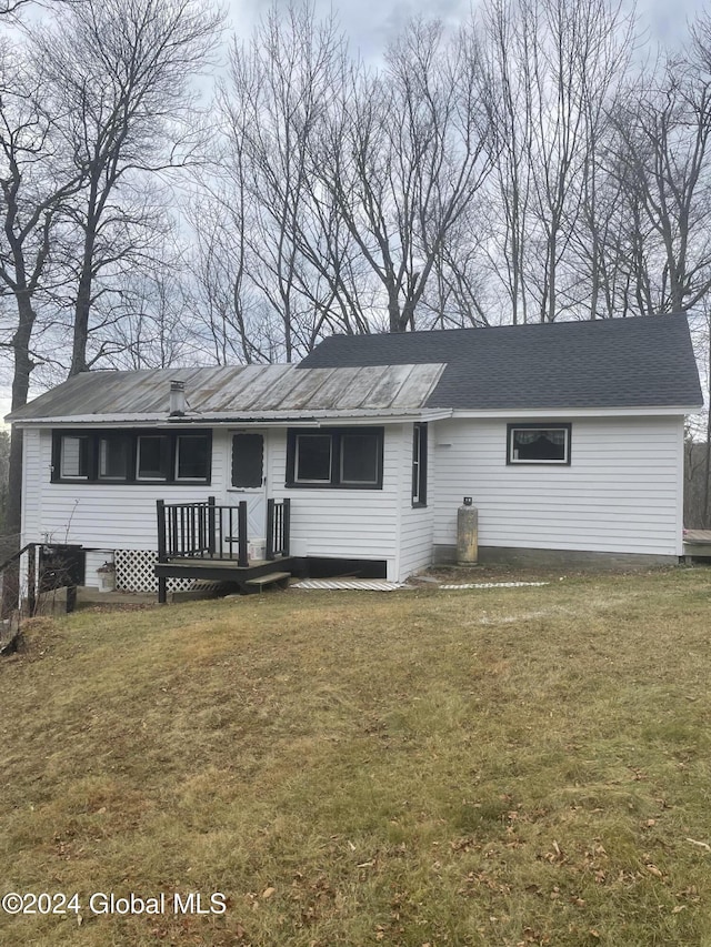 261 Fox Hill Rd, Edinburg, NY 12134 - view of front of house with a front yard, metal roof, and a deck