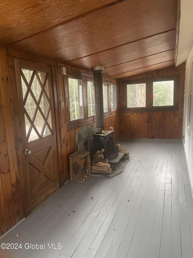 261 Fox Hill Rd, Edinburg, NY 12134 - sunroom featuring a wood stove, plenty of natural light, and lofted ceiling
