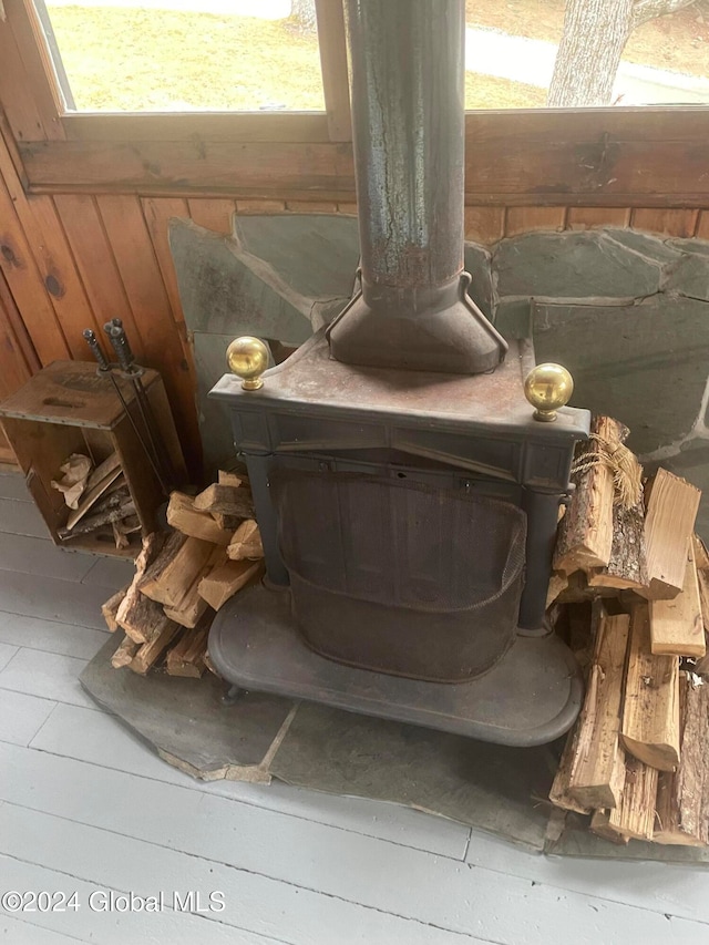 interior details with a wood stove and wooden walls