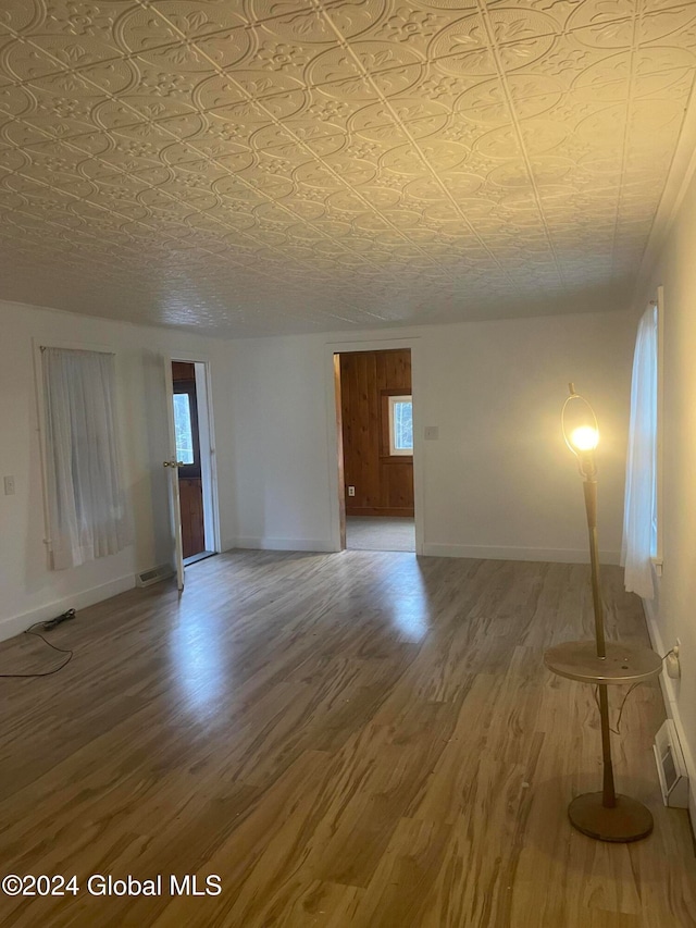 spare room featuring hardwood / wood-style floors and plenty of natural light