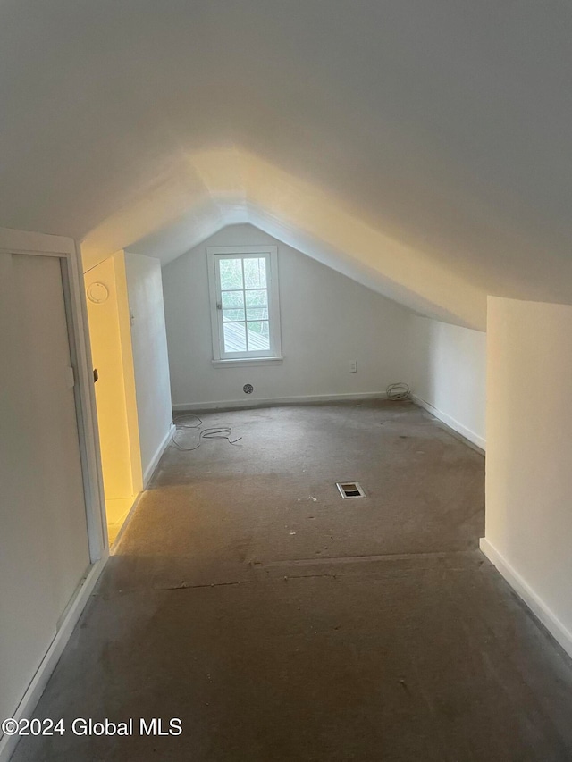 additional living space featuring lofted ceiling