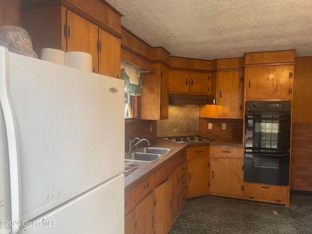 kitchen with sink, double oven, tasteful backsplash, white fridge, and stainless steel gas cooktop