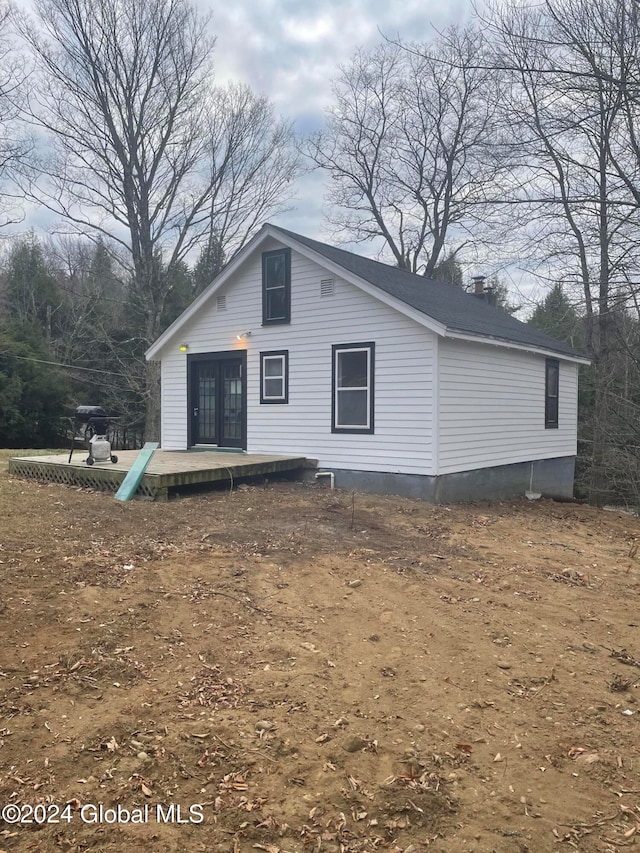 back of property featuring a wooden deck and french doors