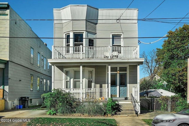 view of front of house featuring a porch and a balcony