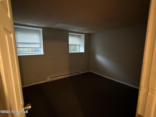 spare room featuring baseboard heating and a wealth of natural light