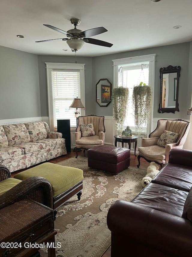 living room with ceiling fan, plenty of natural light, and hardwood / wood-style flooring