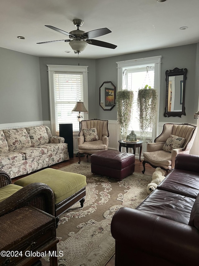 21 Willett St, Fort Plain, NY 13339 - living area with a wainscoted wall, ceiling fan, and wood finished floors