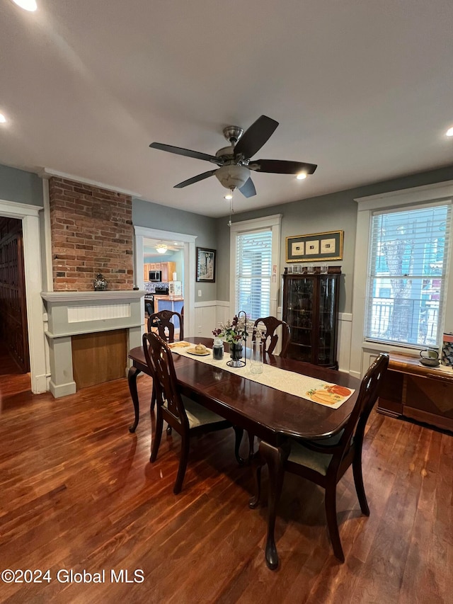 dining space with dark hardwood / wood-style floors and ceiling fan