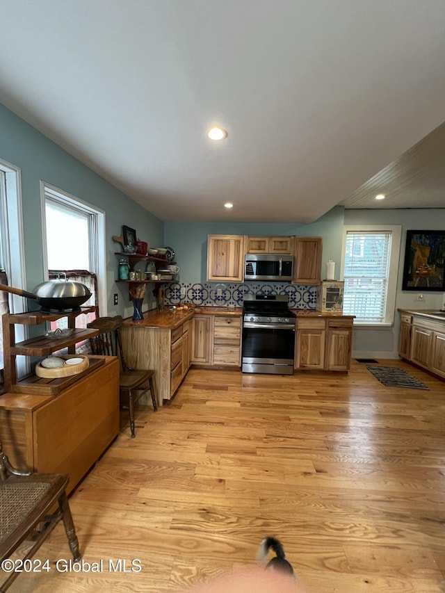 21 Willett St, Fort Plain, NY 13339 - kitchen featuring appliances with stainless steel finishes, light wood-type flooring, recessed lighting, and backsplash