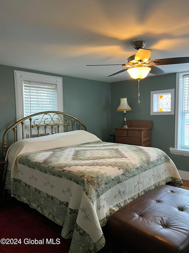 bedroom featuring multiple windows and ceiling fan