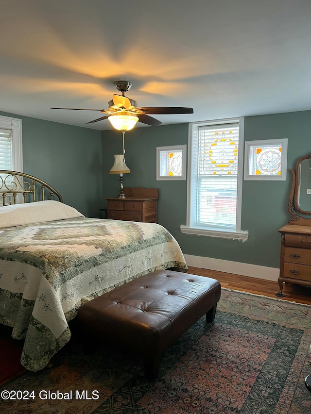 bedroom with ceiling fan and wood-type flooring