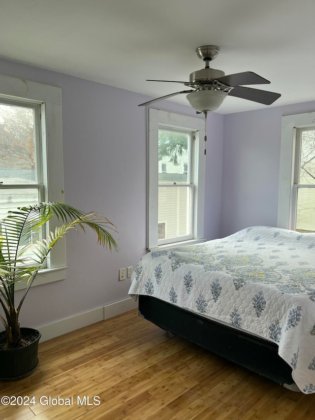 unfurnished bedroom with ceiling fan and wood-type flooring