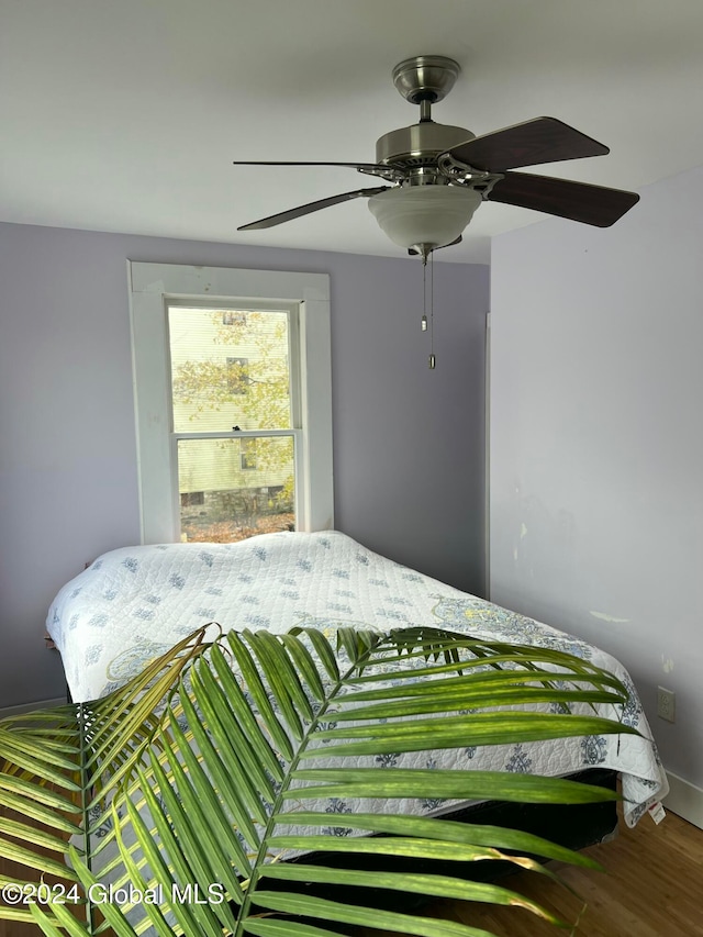 bedroom featuring ceiling fan and wood-type flooring