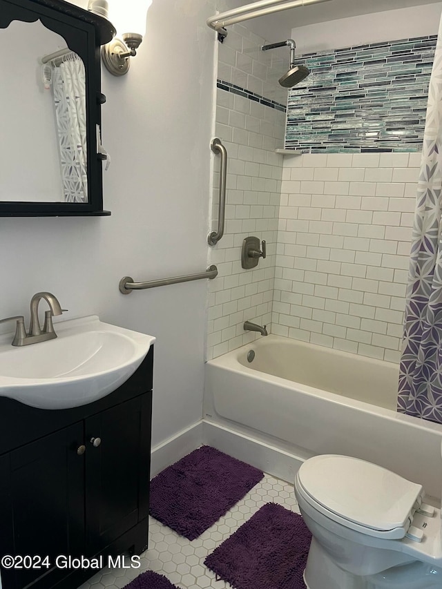 full bathroom featuring toilet, tile patterned floors, vanity, and shower / tub combo with curtain