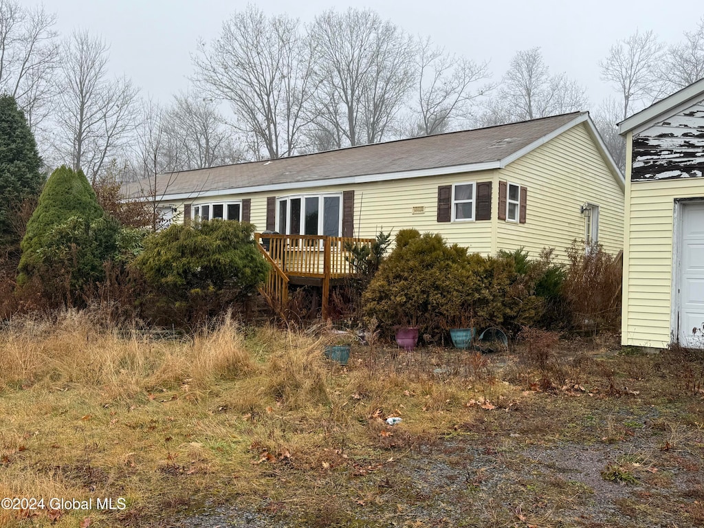 back of house featuring a deck