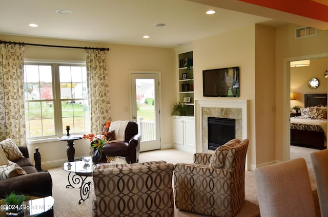 living room featuring light colored carpet and built in features