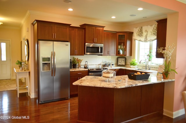 kitchen featuring light stone countertops, stainless steel appliances, dark hardwood / wood-style floors, kitchen peninsula, and ornamental molding