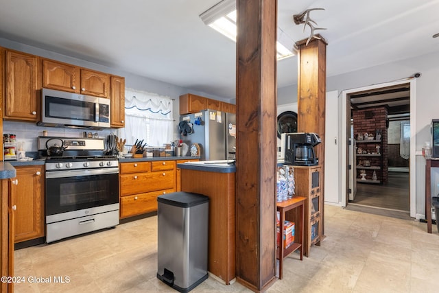 kitchen featuring appliances with stainless steel finishes and tasteful backsplash