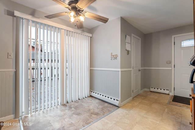 foyer entrance featuring ceiling fan and baseboard heating