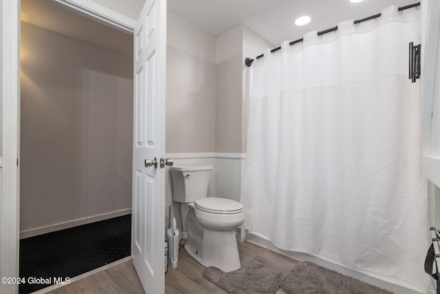 bathroom featuring hardwood / wood-style floors and toilet