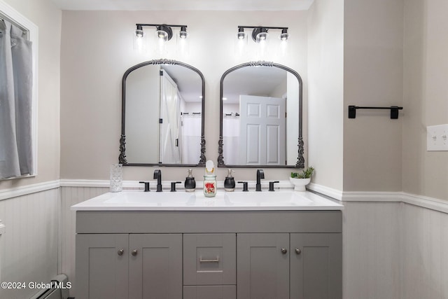 bathroom with vanity and a baseboard heating unit