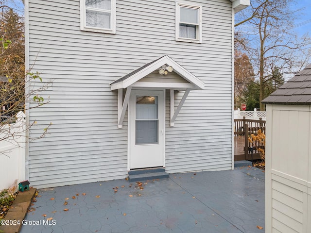 view of exterior entry with a patio