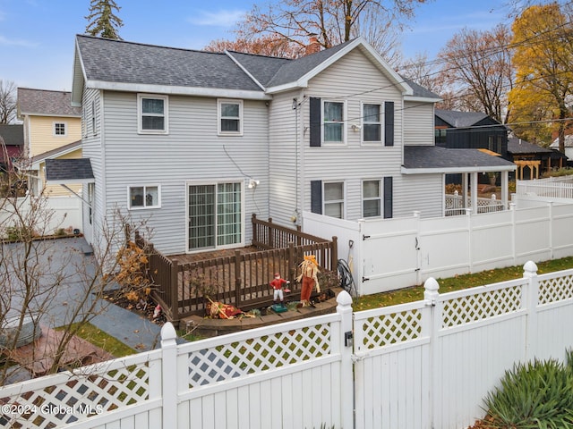 rear view of property featuring a deck