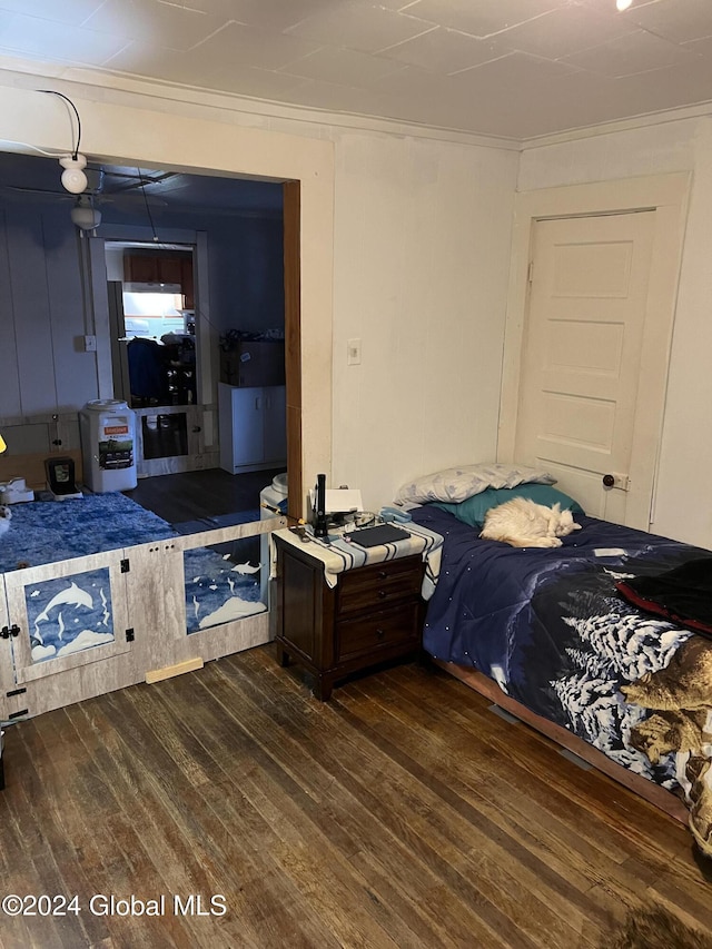 bedroom featuring dark hardwood / wood-style flooring and crown molding