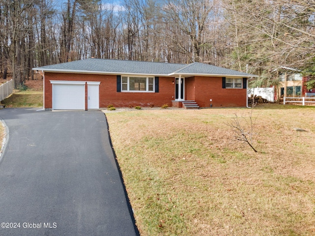 single story home featuring a front yard and a garage