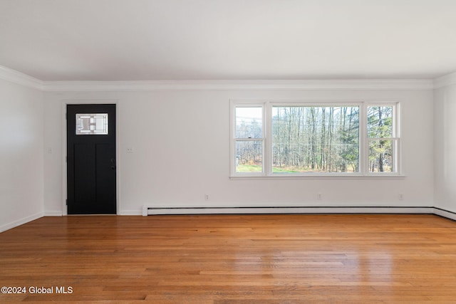 entryway featuring baseboard heating, crown molding, and light hardwood / wood-style flooring