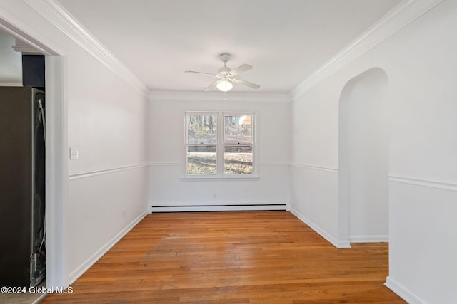 empty room featuring ceiling fan, light hardwood / wood-style flooring, a baseboard heating unit, and ornamental molding