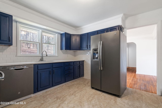 kitchen with appliances with stainless steel finishes, light wood-type flooring, blue cabinets, crown molding, and sink