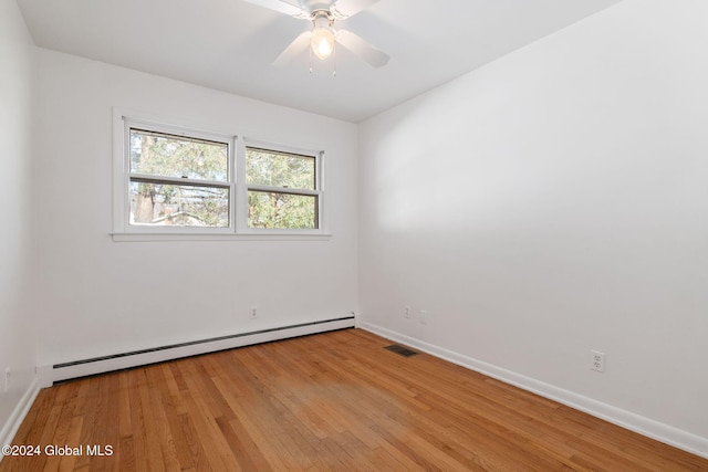 unfurnished room with ceiling fan, light hardwood / wood-style flooring, and a baseboard heating unit