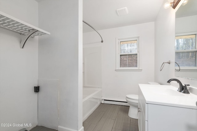 full bathroom featuring washtub / shower combination, toilet, vanity, and a baseboard heating unit