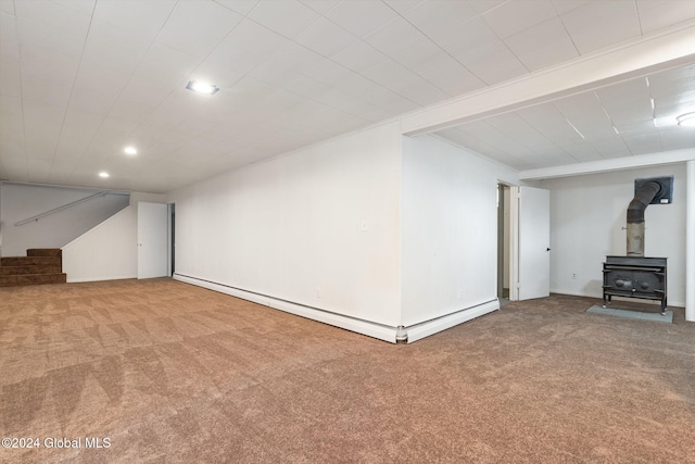 unfurnished living room with carpet flooring and a wood stove