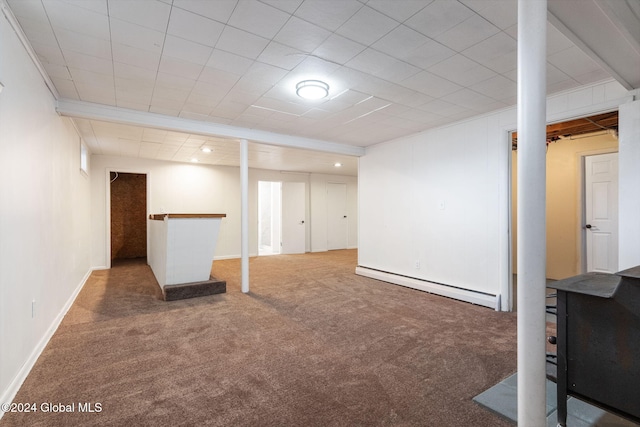 basement with carpet floors and a baseboard heating unit