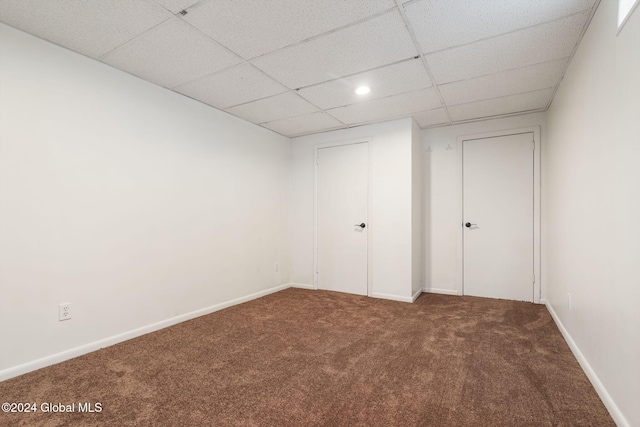 interior space with carpet flooring and a paneled ceiling