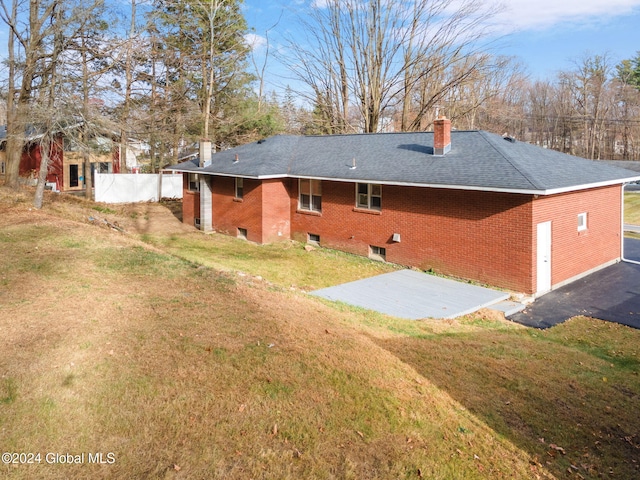 back of house featuring a yard and a patio