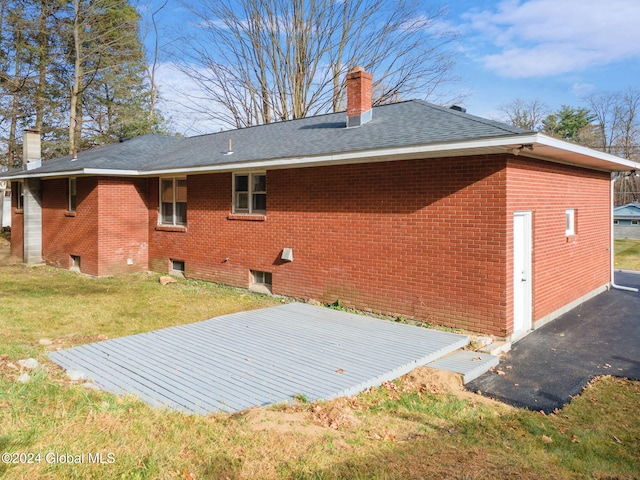 rear view of property with a lawn