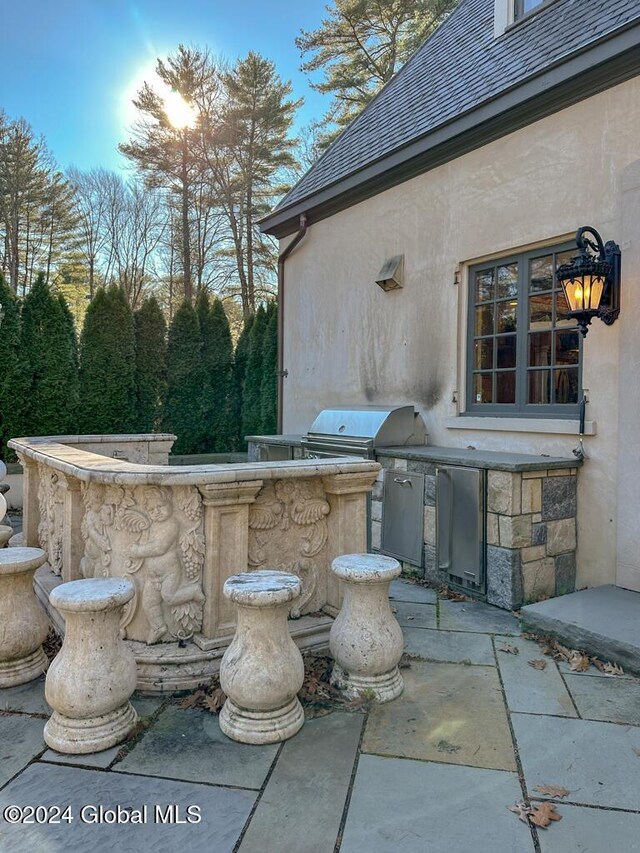 view of patio featuring exterior kitchen and grilling area