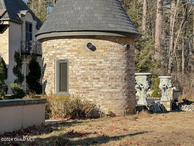 view of side of home with a balcony