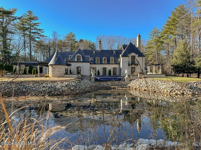 rear view of house with a water view